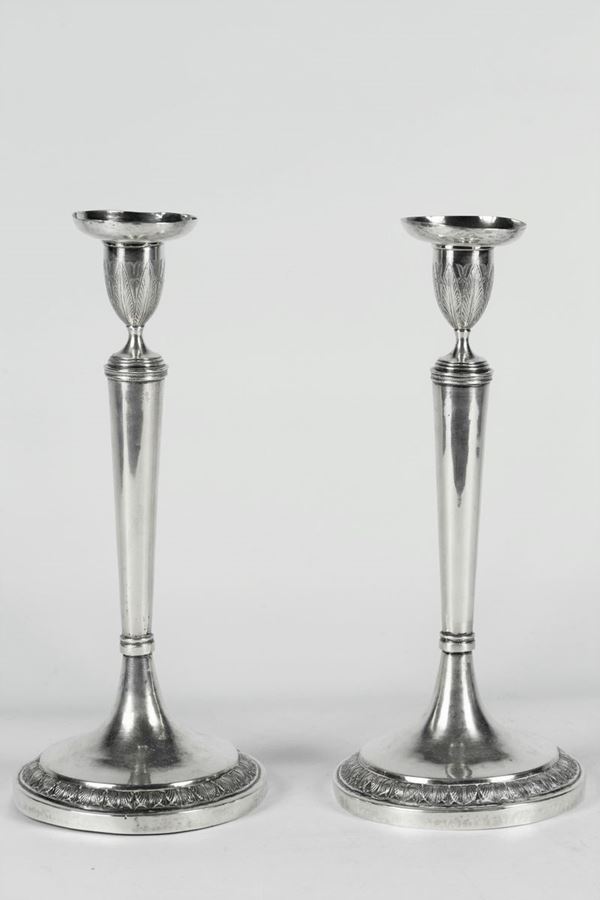 Pair of Roman candlesticks in silver