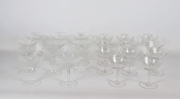 Lot of twenty-two crystal champagne glasses, eleven with embossed star engravings and eleven with embossed leaf engravings. Manufacture Early 20th Century