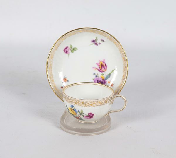 Antique cup and saucer in German porcelain Berlin KPM, with polychrome decorations of bunches of flowers and pure gold. Manufacture Late 19th Century