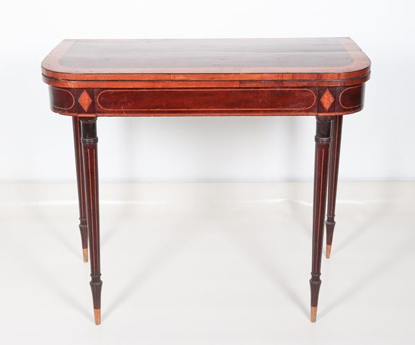 Victorian English mahogany games table with satin band inlaid top and conical legs, fold-down top with green cloth inside