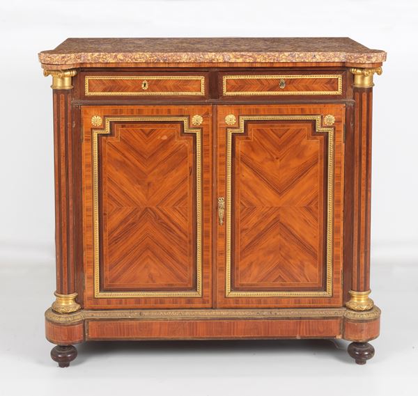 Antique French Napoleon III sideboard in purple ebony, rosewood and mahogany, with inlaid fillets and gilded bronze, embossed and chiselled decorations and friezes, fluted neoclassical column uprights, two drawers with two doors underneath and onion legs. Brecciated marble top