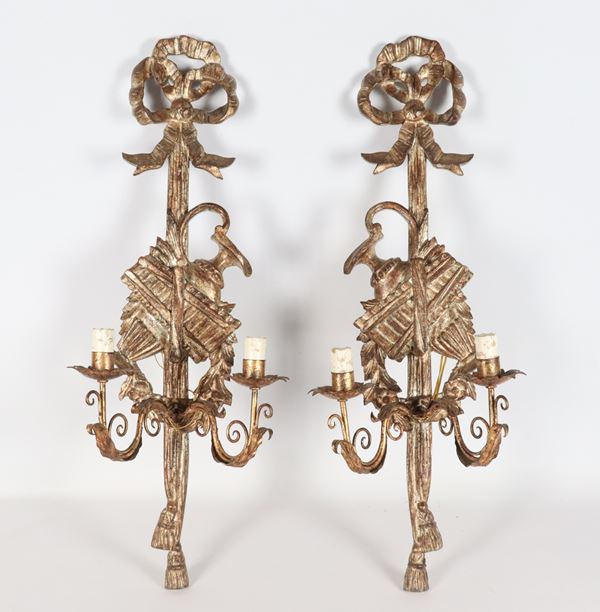 Pair of gilded and silvered wood wall lamps, carved with Louis XVI bow motifs, 2 lights each