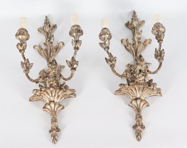 Pair of silvered wooden mecca sconces, carved with amphora motifs with flowers and leaves, 2 lights each