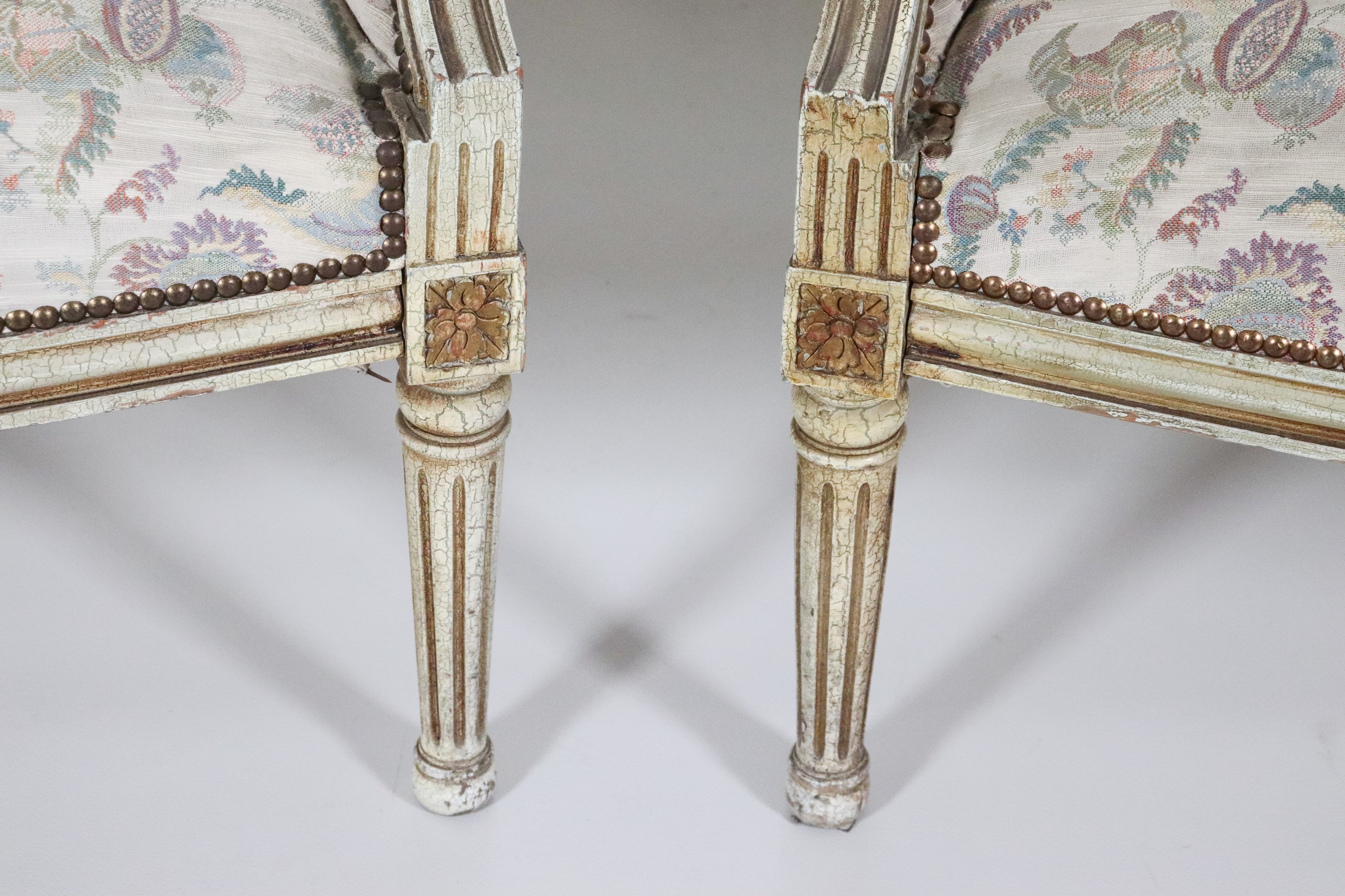 Coppia di poltrone francesi di linea Luigi XVI, in legno laccato bianco e dorato, copertura in te...