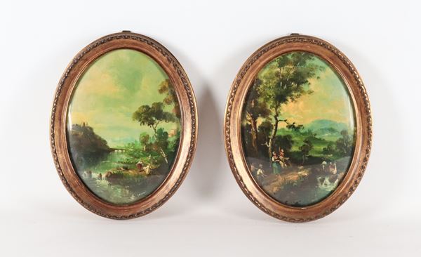 Coppia di miniature ovali dipinte "Paesaggi con contadini e corso d'acqua", cornicette in legno dorato