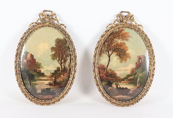 Coppia di miniature ovali dipinte "Paesaggi con ruderi e borgo", cornici in metallo dorato, sbalzato e cesellato a motivi Luigi XVI