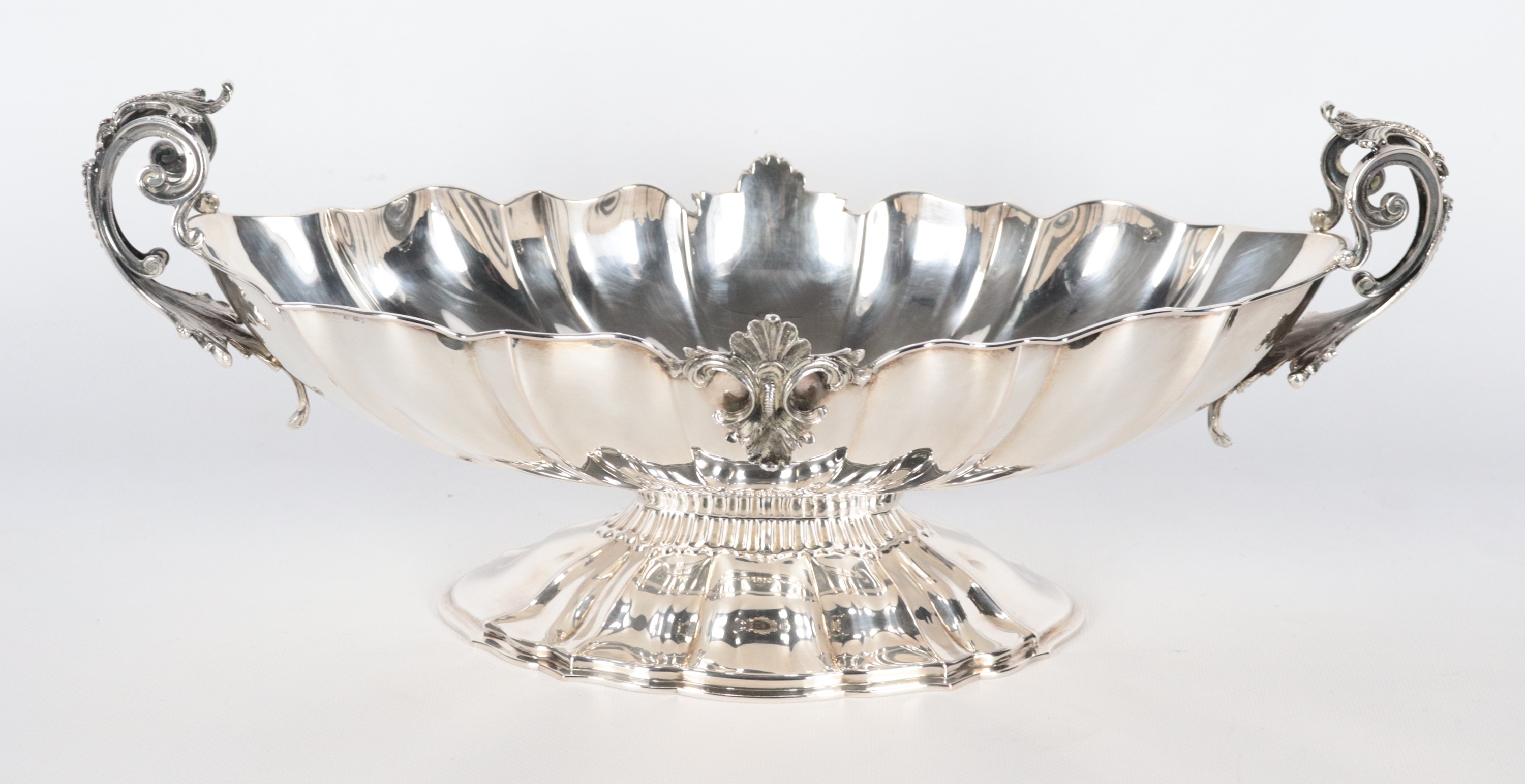 Centrotavola ovale in argento, con bordo sagomato, cesellato e sbalzato a motivi di conchiglie e ...