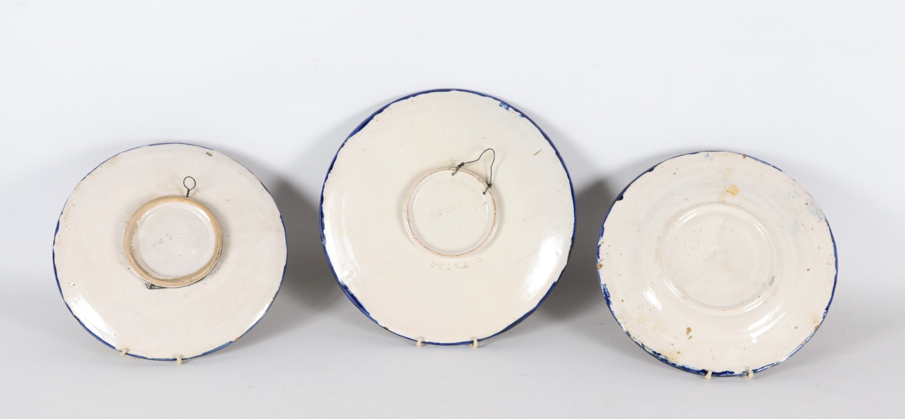 Lotto di tre antichi piatti da muro in maiolica lustrata di Faenza