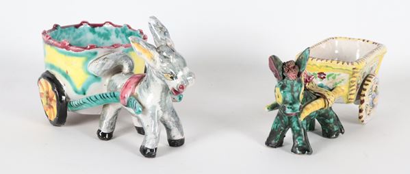 Lotto di due carretti siciliani con asinelli in ceramica porcellanata e policroma, forme lievemente differenti
