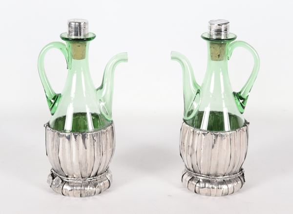 Coppia di ampolle, olio e aceto, a forma di fiaschetti in vetro con rivestimento in argento
