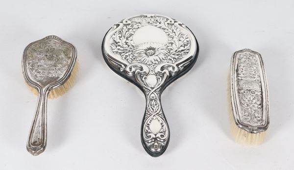 Lot of a mirror and two toilet brushes covered in chiseled and embossed silver (3 pcs.)