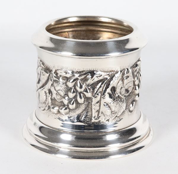 Silver metal bottle holder with embossed bunches of grapes