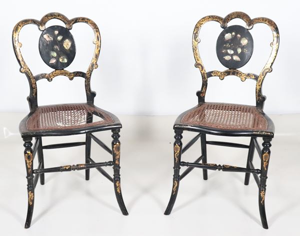 Pair of ebonized wooden chairs with mother-of-pearl inlays and golden floral scrolls