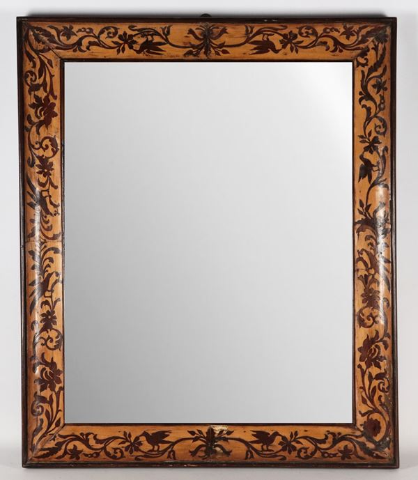 Antique wooden frame decorated with plant scrolls