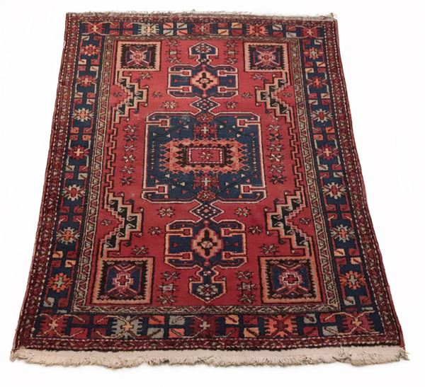 Persian Kazak carpet with geometric designs on a red background, M. 2 x 1.30