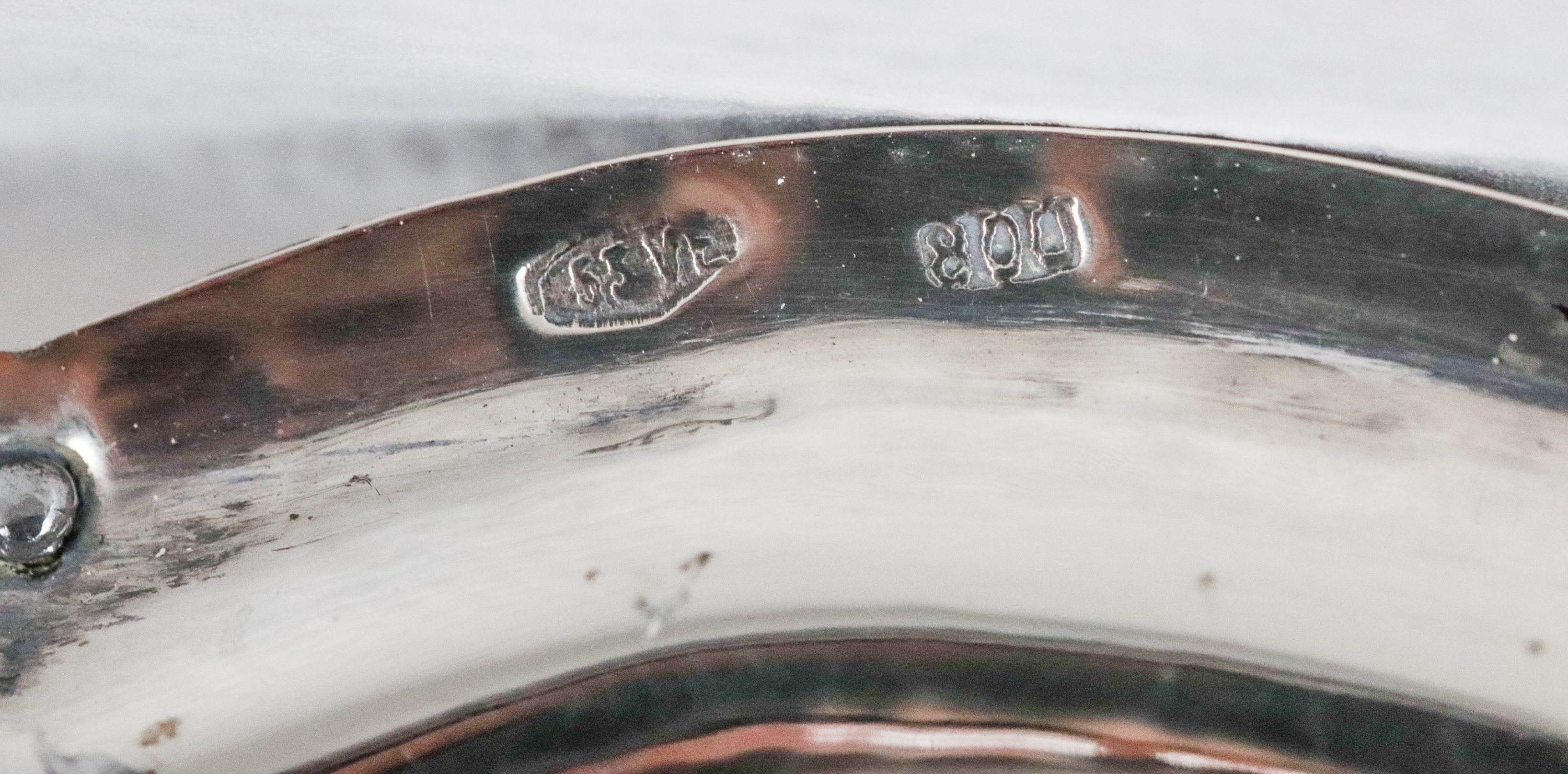 Antica specchiera sagomata in argento cesellato e sbalzato