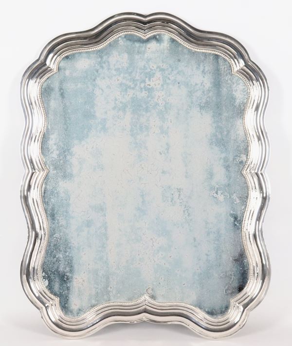 Antique shaped mirror in chiseled and embossed silver
