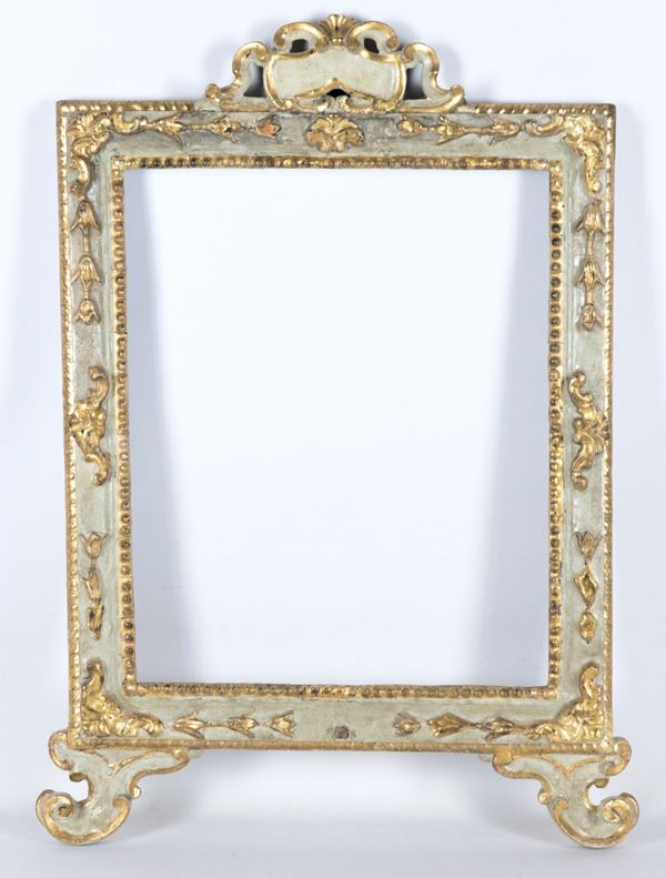 Antique frame in light blue lacquered wood with carved and gilded friezes