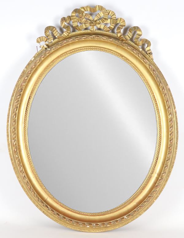 French mirror in gilded wood and carved with Louis XVI motifs