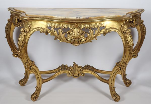 Console in gilded wood and carved with Louis XV motifs, top in antique yellow marble
