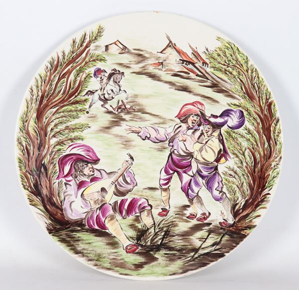 Wall plate in porcelain and enamelled ceramic with a scene of travelling singers