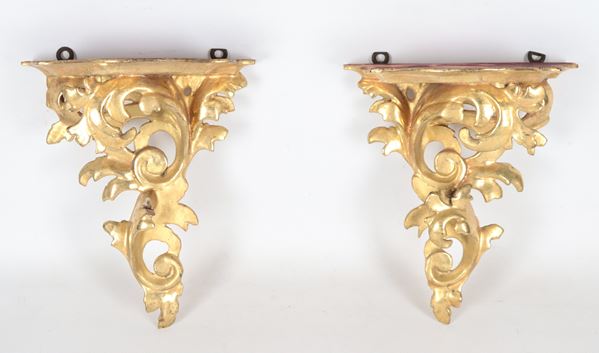 Pair of antique porcelain holders in gilded wood and carved with floral scrolls