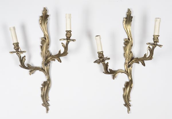 Pair of antique French wall lamps in gilded and chiseled bronze with Louis XV motifs, 2 lights each