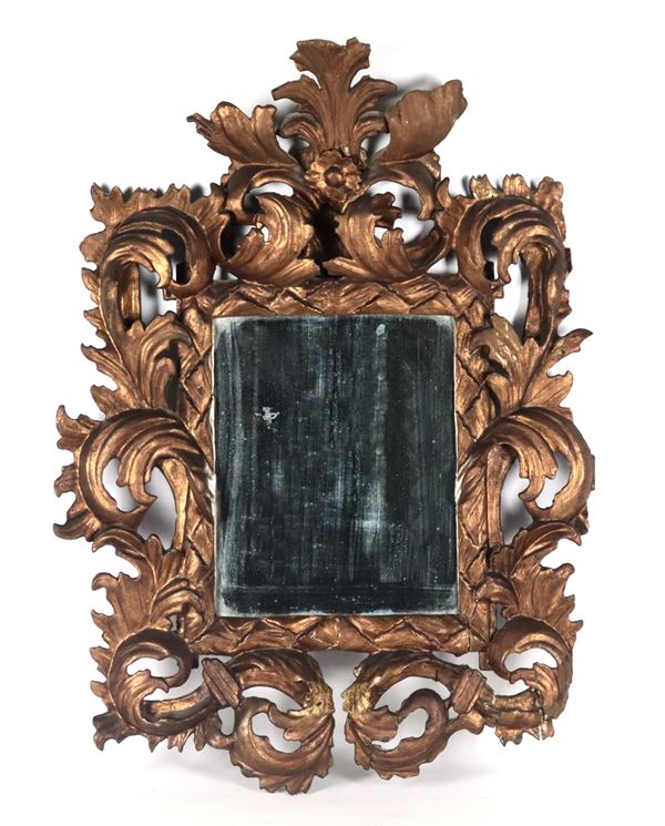 Antique small mirror in gilded wood and carved with Louis XIV motifs of scrolls and acanthus leaves, mercury mirror