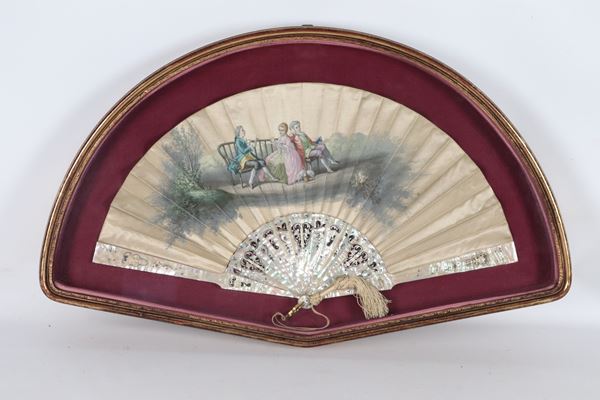 Antique fan with a painted gallant scene in a gilded wooden display case frame
