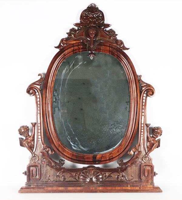 Antique Neapolitan Louis Philippe mirror in walnut, with carved cymatium and sculptures of cherubs 