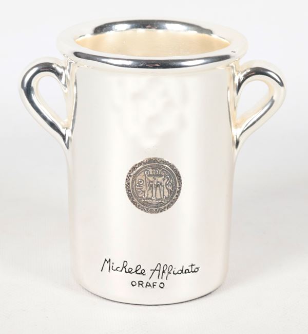 Small vase by the goldsmith Michele Affidato, in galvanized marble dust composite coated in silver, with application of a 925 silver coin depicting "The Stater", an ancient coin of Magna Graecia.