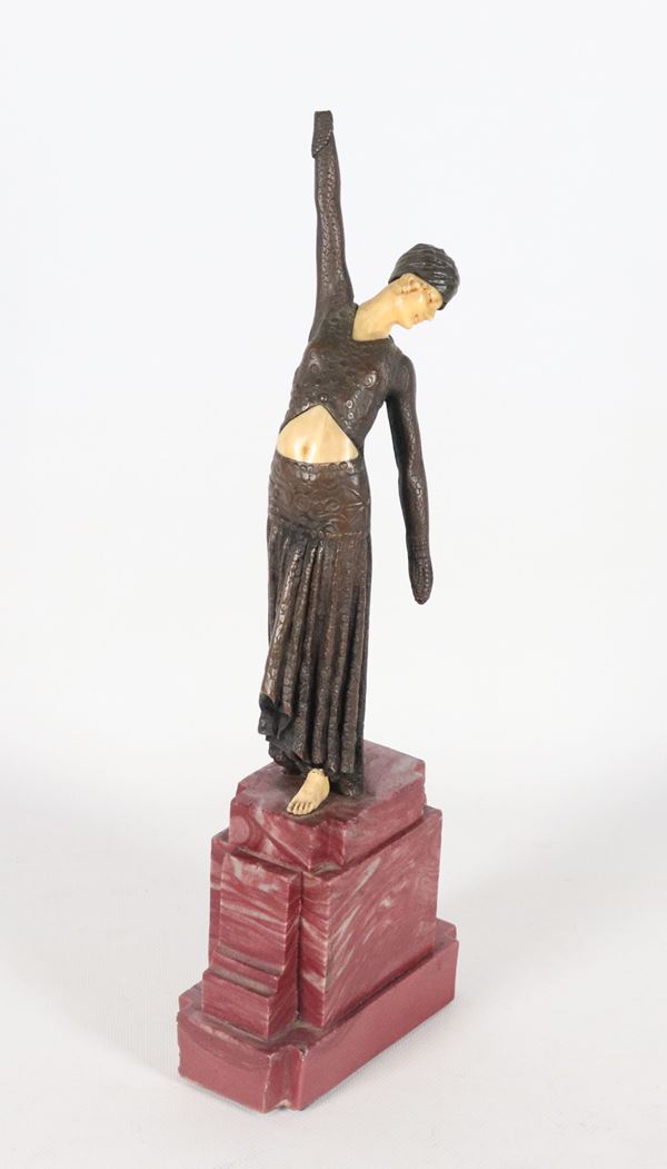 "Ballerina", a small Art Deco sculpture in bronzed metal, supported by a red marble base. Signed. 
