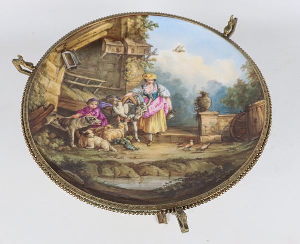 Antique French gilded bronze stand, embossed and chiseled, with central plate in polychrome porcelain with peasant scene