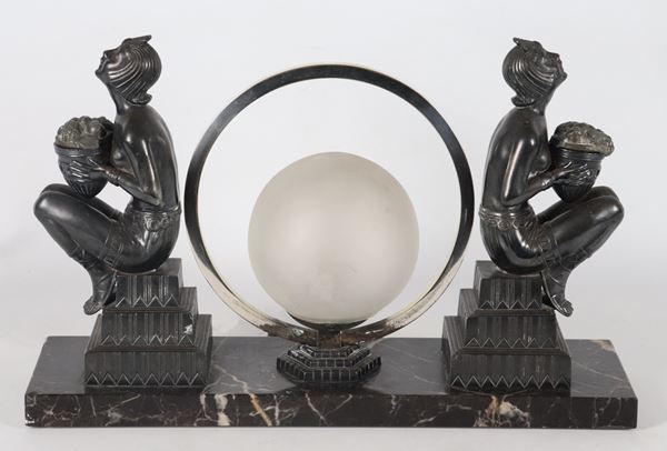 French Art Nouveau table lamp, made up of two bronze odalisque sculptures with a small milk glass globe and silvered circle in the centre, marble base