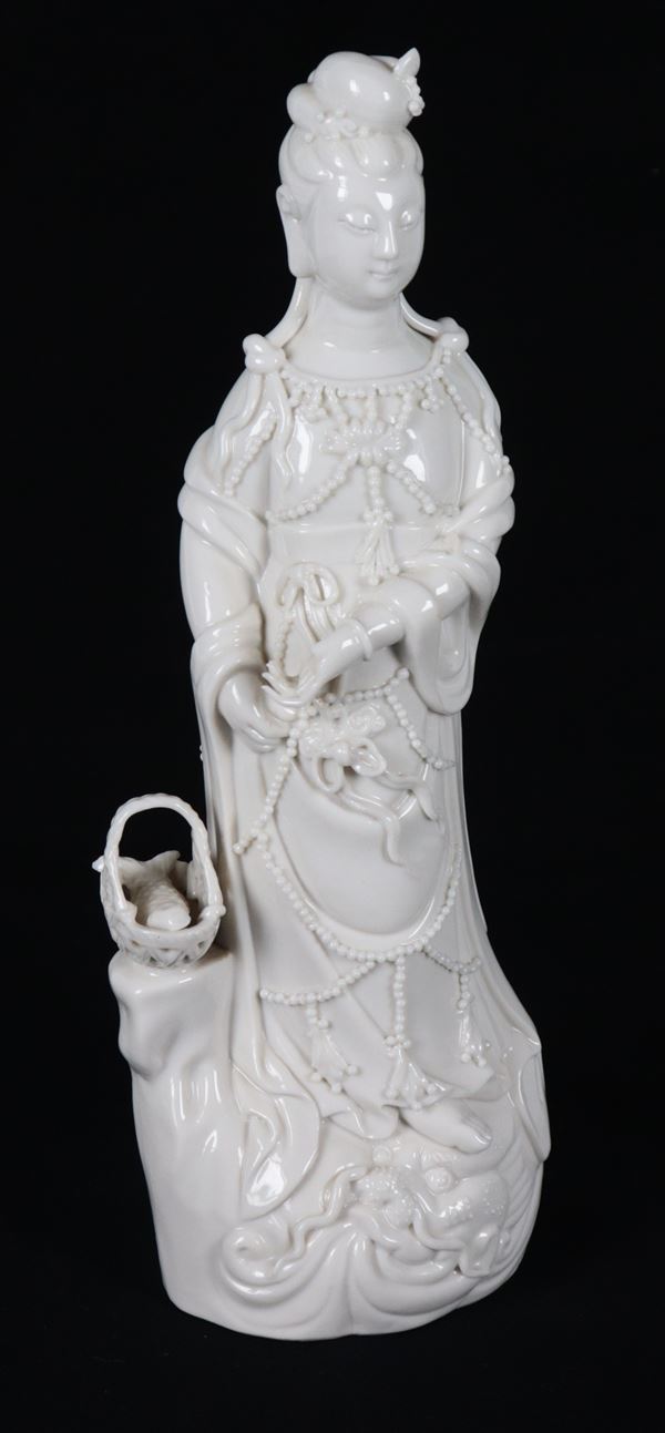 "Guanyin with a Basket of Fish", a small antique Chinese white porcelain sculpture