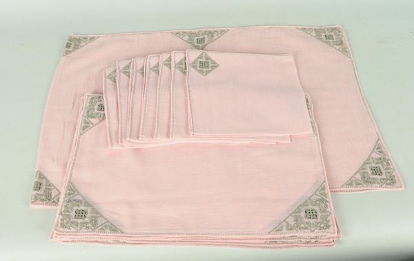 Table set of a rectangular centerpiece and eight placemats with eight embroidered pink cotton muslin napkins