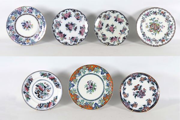 Lot of seven antique English porcelain wall plates, with floral decorations in polychrome enamels in relief.