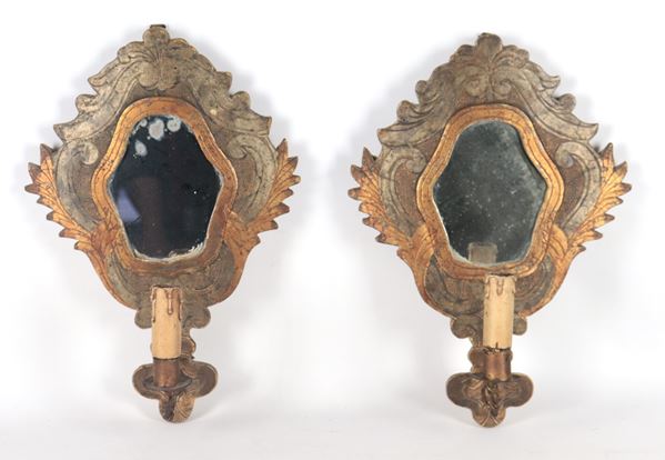 Pair of antique mirrors in gilded and silvered wood, carved with Louis XIV motifs, mercury mirrors and one light each 