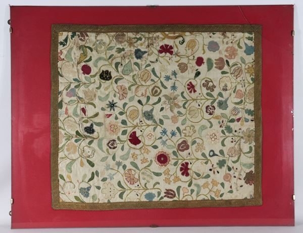 Ancient embroidered fabric drape with polychrome floral allegory motifs