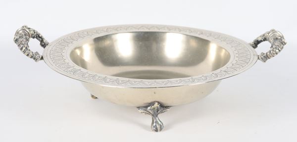 Small round fruit bowl in silver-plated metal with two embossed handles, supported by three curved feet