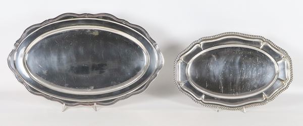 Lot of two oval serving plates in silver metal with shaped and embossed edges 