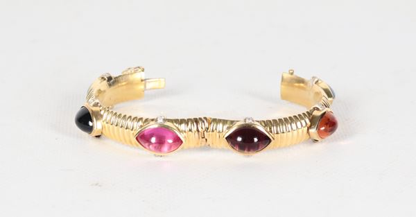 Bracciale rigido in oro giallo 18kt con pietre colorate e piccoli diamanti ct 0,45 circa. Peso lordo gr. 50,5