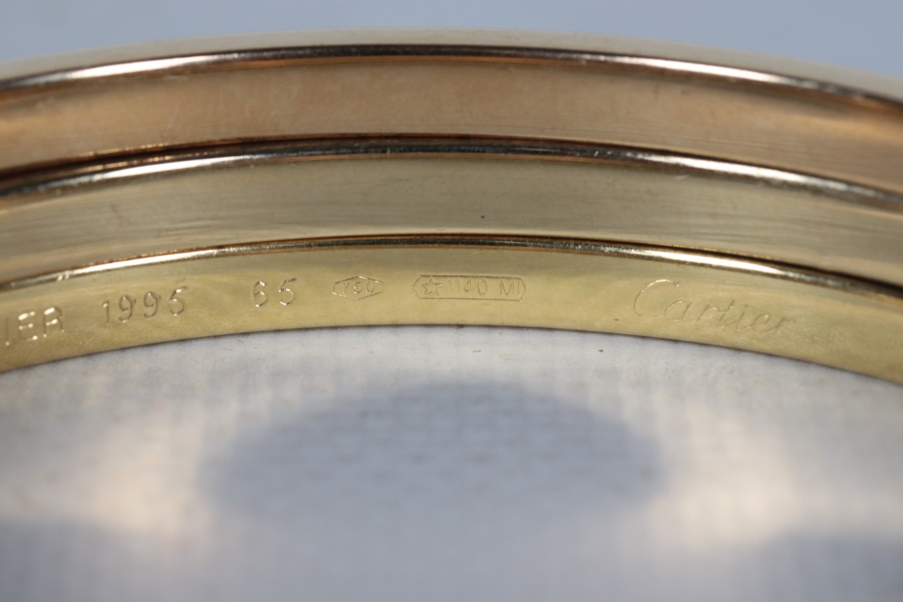 Bracciale in oro giallo 18kt, formato da tre cerchi uniti. Peso gr. 60,5