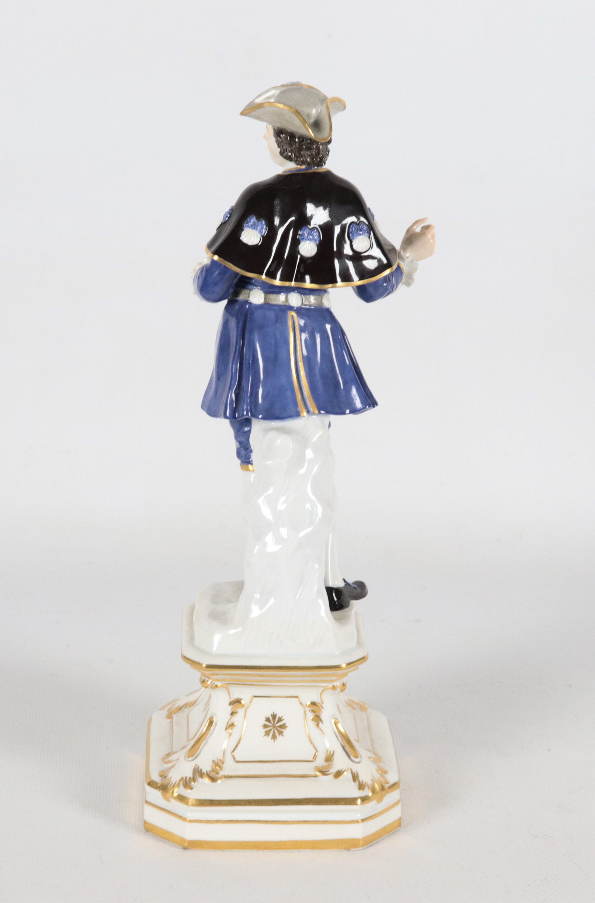 "Cavaliere con mantella", antica piccola scultura in porcellana policroma Meissen, sorretta da ba...