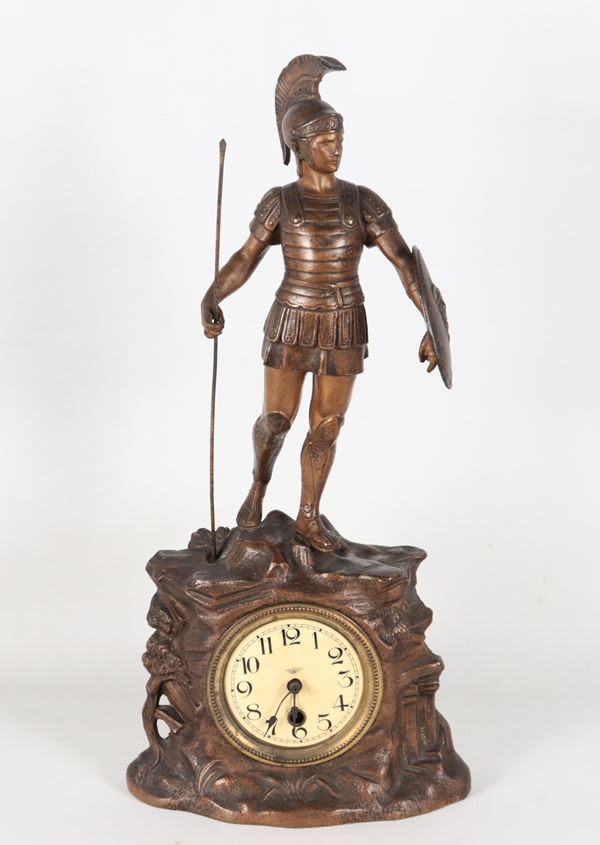 Orologio da tavolo in metallo bronzato sormontato da scultura di soldato romano