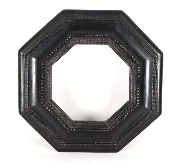 Antica piccola cornice ottagonale in pero ebanizzato e intagliato