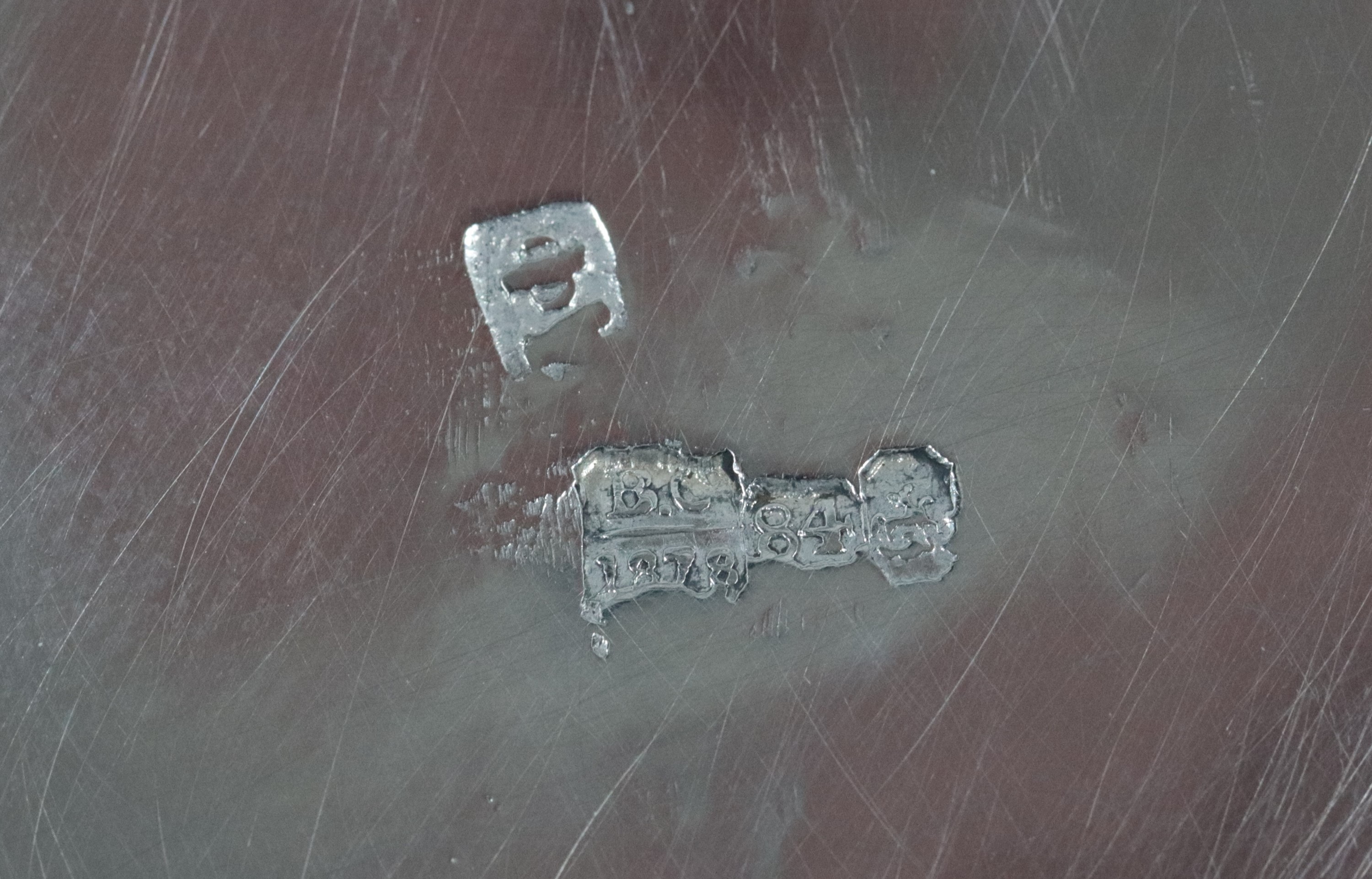 Antica tazzina con piattino, in argento cesellato e sbalzato a motivi di intrecci geometrici, gr....