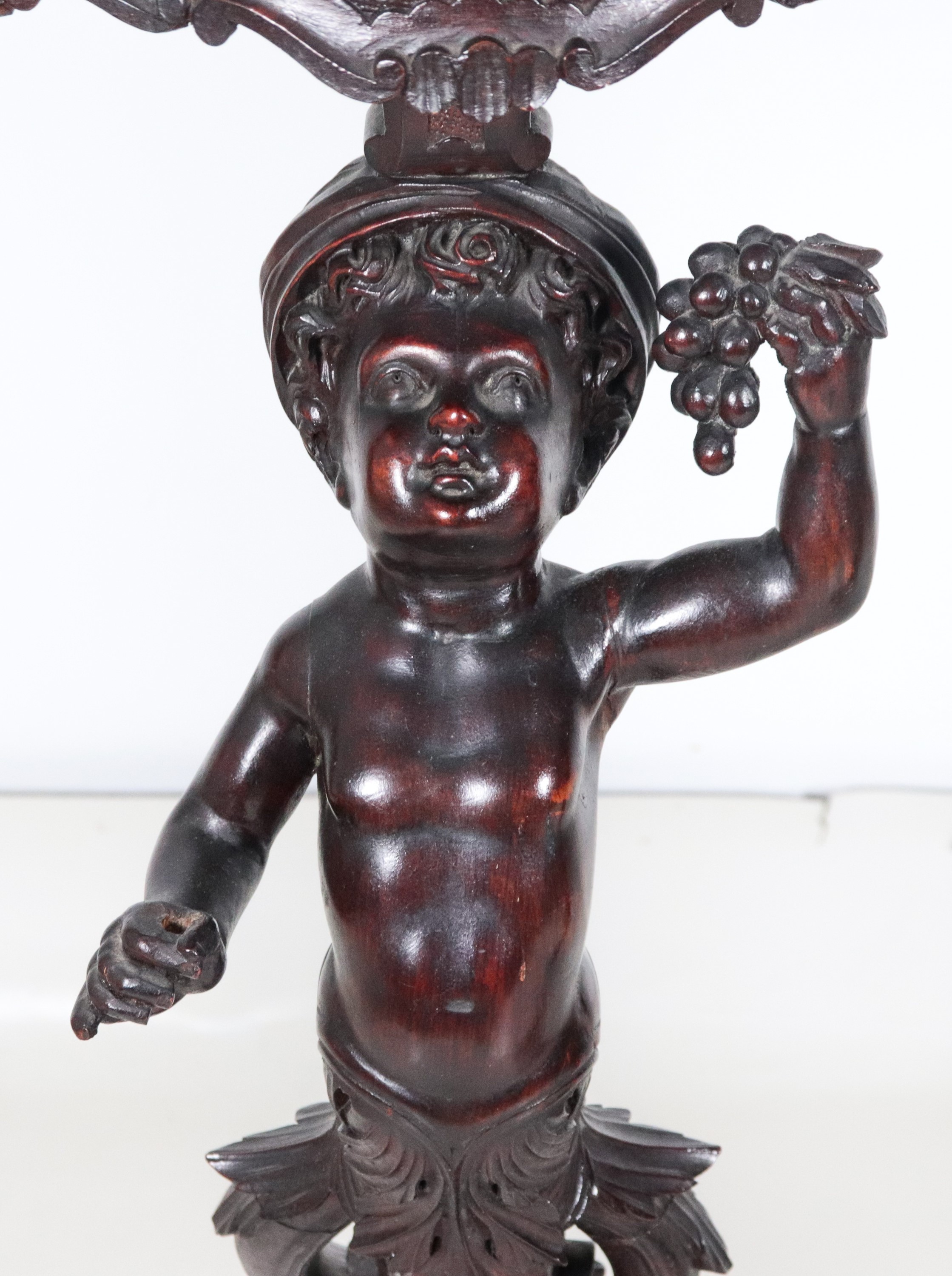 Coppia di antichi trespoli veneziani in noce, con sculture di "Moretti" e tre gambe centinate