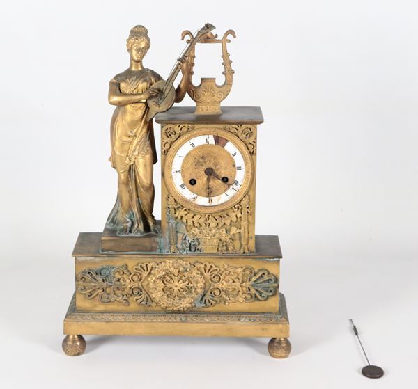 Antica pendola da camino francese in bronzo dorato, sbalzato e cesellato con scultura di Musa