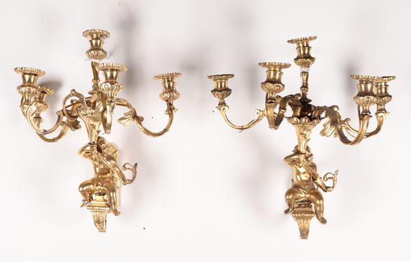 Pair of antique French gilded bronze wall lamps with sculptures of cherubs and cornucopias